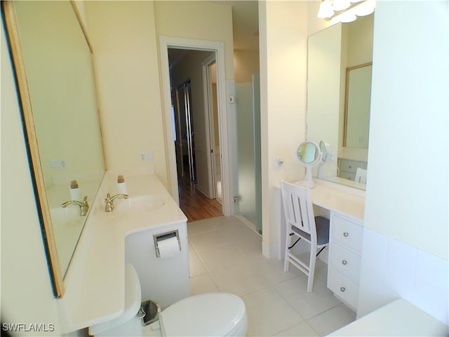 bathroom featuring toilet, tile patterned flooring, and sink