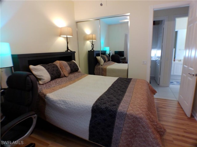 bedroom with wood-type flooring and a closet