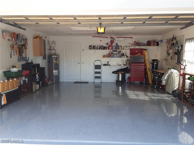 garage featuring a garage door opener and electric water heater