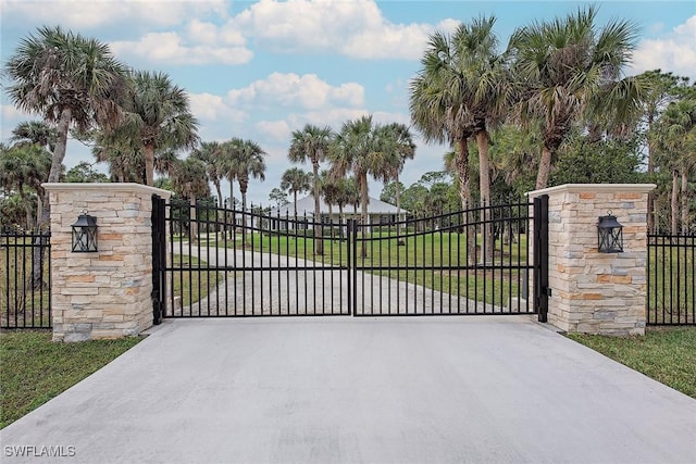 view of gate with a yard