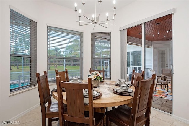 tiled dining room with a chandelier and a healthy amount of sunlight