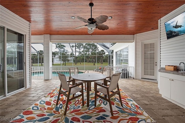 sunroom featuring sink and ceiling fan