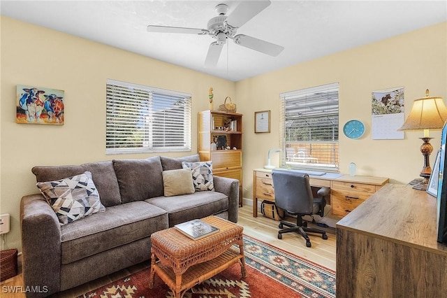 home office with ceiling fan and light wood-type flooring