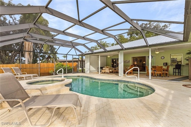 view of swimming pool featuring glass enclosure, an in ground hot tub, outdoor lounge area, a patio, and ceiling fan