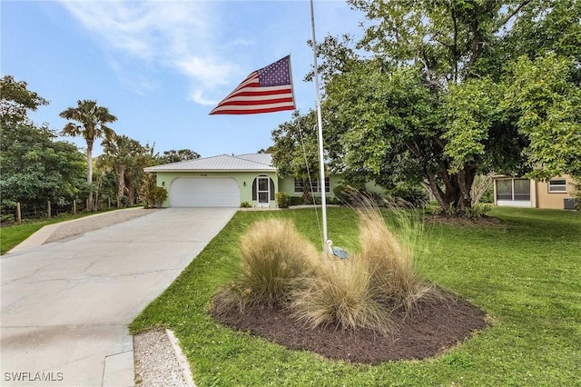 view of front of house with a garage and a front lawn