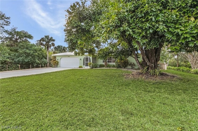 view of front of home featuring a garage and a front lawn