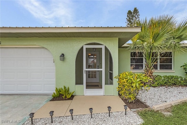 view of exterior entry with a garage