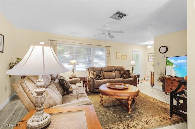 living room with ceiling fan and light wood-type flooring