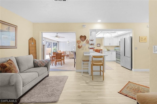 living room with light hardwood / wood-style flooring