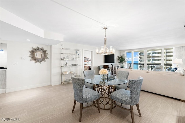 dining space with an inviting chandelier