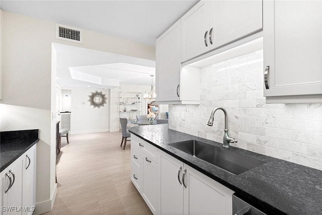 kitchen featuring sink, white cabinets, and tasteful backsplash