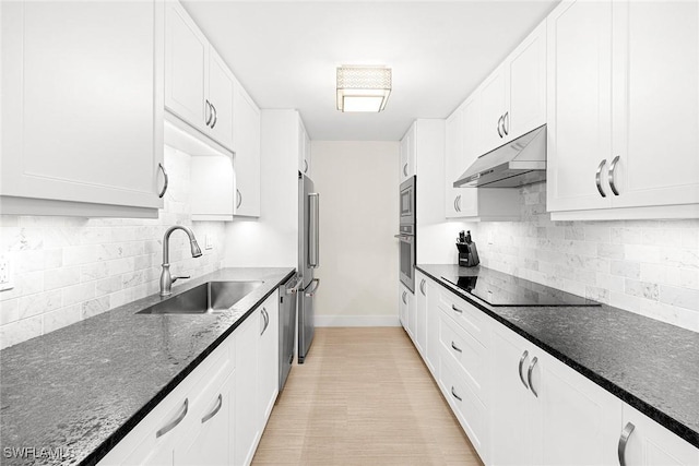 kitchen featuring sink, tasteful backsplash, white cabinetry, and stainless steel appliances