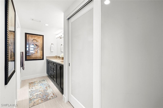 bathroom featuring hardwood / wood-style floors and vanity