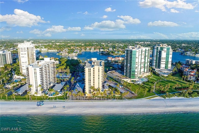 birds eye view of property featuring a water view and a beach view