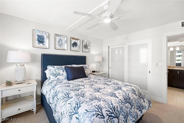 carpeted bedroom with ceiling fan and connected bathroom