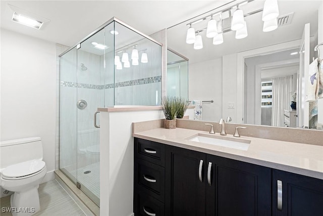 bathroom with a shower with door, toilet, tile patterned floors, and vanity