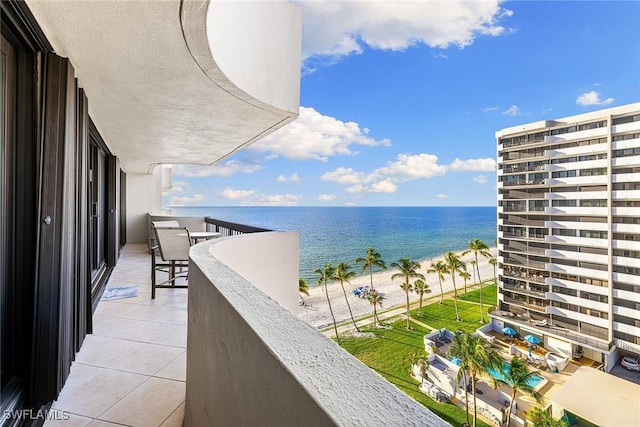 balcony featuring a water view and a beach view