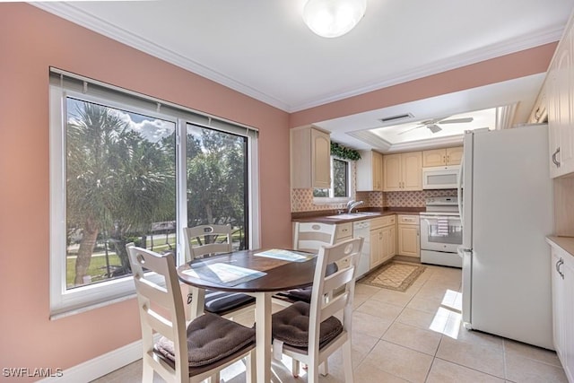 kitchen with white appliances, light tile patterned floors, sink, ornamental molding, and backsplash