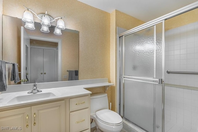 bathroom featuring vanity, toilet, and walk in shower