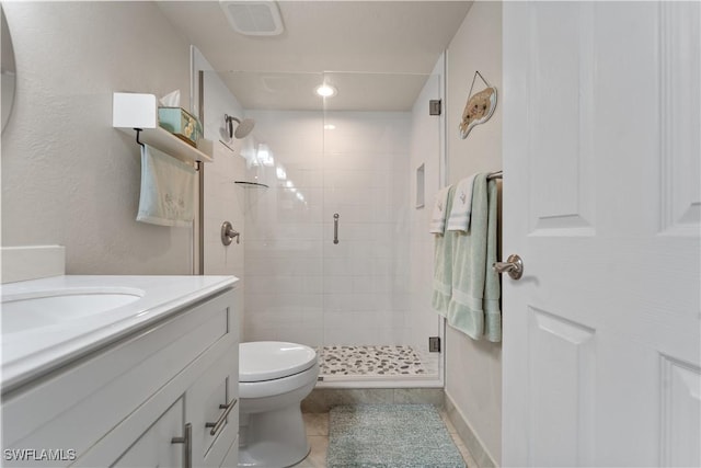 bathroom with vanity, a shower with door, tile patterned floors, and toilet