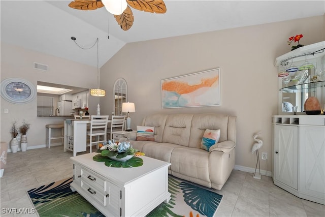 tiled living room featuring vaulted ceiling, sink, and ceiling fan