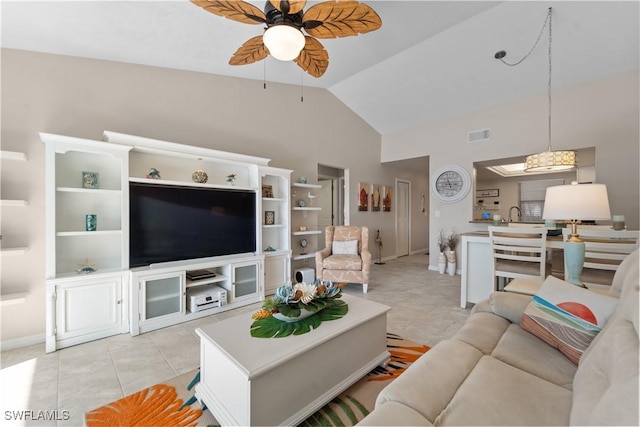 living room with lofted ceiling, sink, light tile patterned floors, and ceiling fan