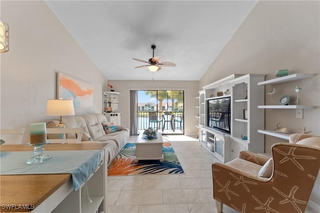 living room featuring ceiling fan, vaulted ceiling, and light tile patterned floors