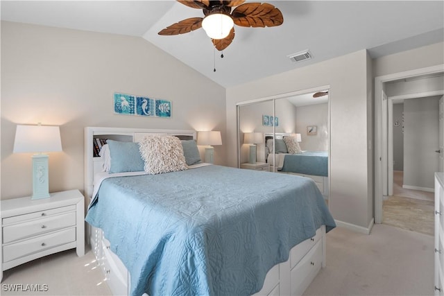 bedroom featuring light carpet, lofted ceiling, a closet, and ceiling fan