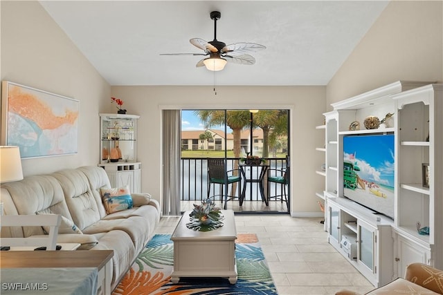 living room with lofted ceiling, light tile patterned floors, and ceiling fan