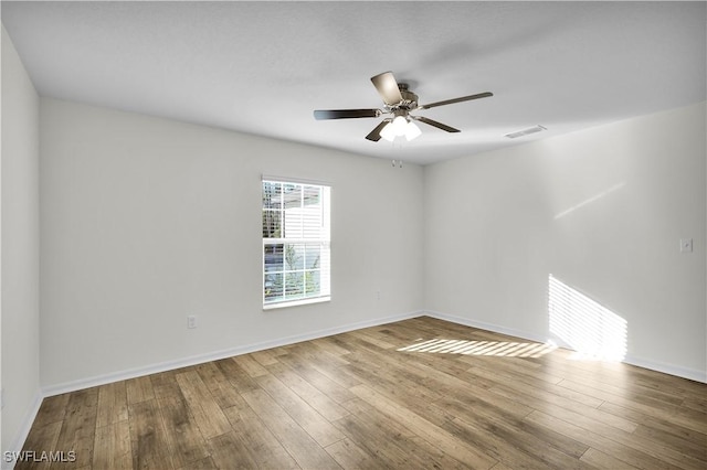 spare room featuring hardwood / wood-style flooring and ceiling fan