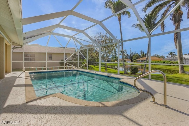 view of pool featuring glass enclosure, a patio area, and a water view