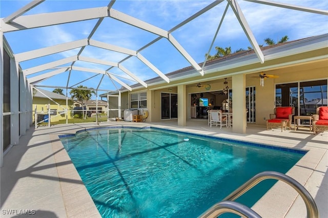 view of pool featuring a lanai, a patio area, an outdoor hangout area, and ceiling fan