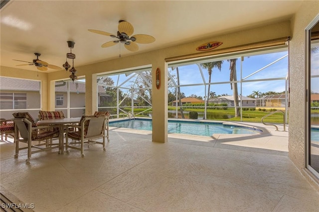 view of pool with a water view and ceiling fan