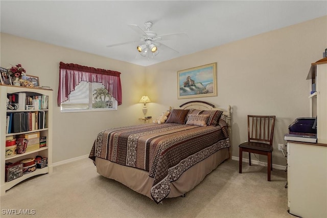 bedroom with ceiling fan and light carpet