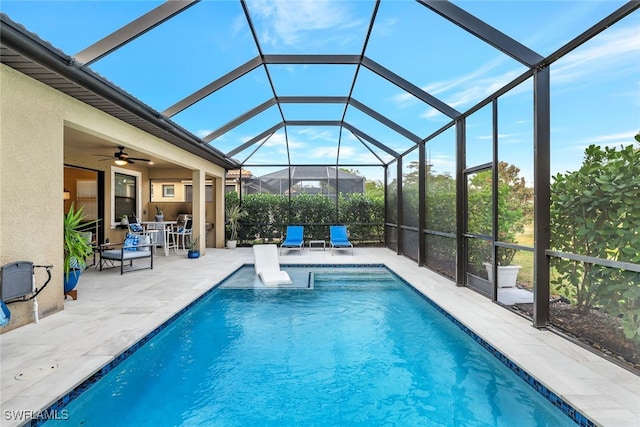 view of swimming pool with a patio area, ceiling fan, and glass enclosure