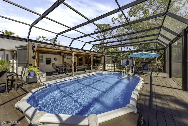 view of swimming pool with glass enclosure