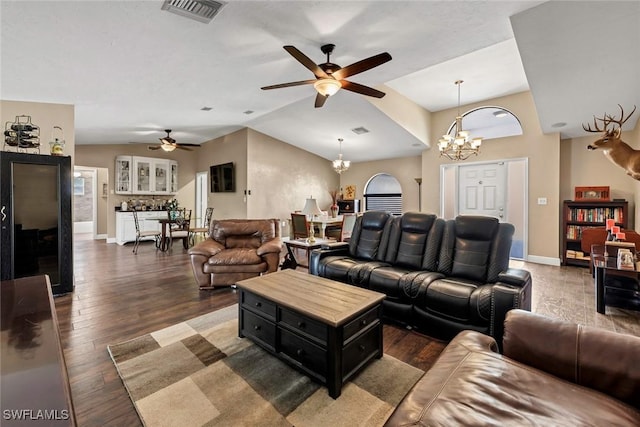 living room featuring lofted ceiling, ceiling fan with notable chandelier, and dark wood-type flooring