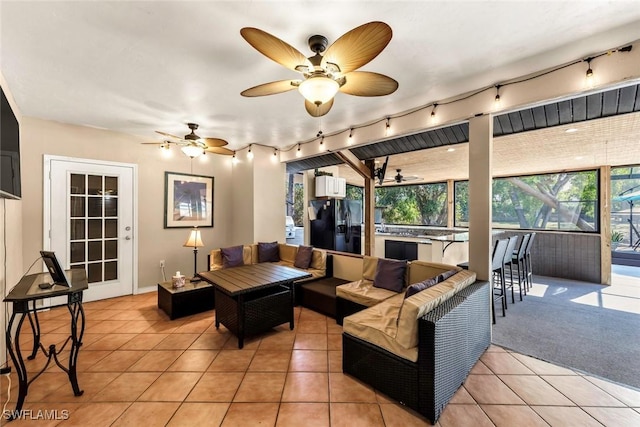 tiled living room with rail lighting and ceiling fan