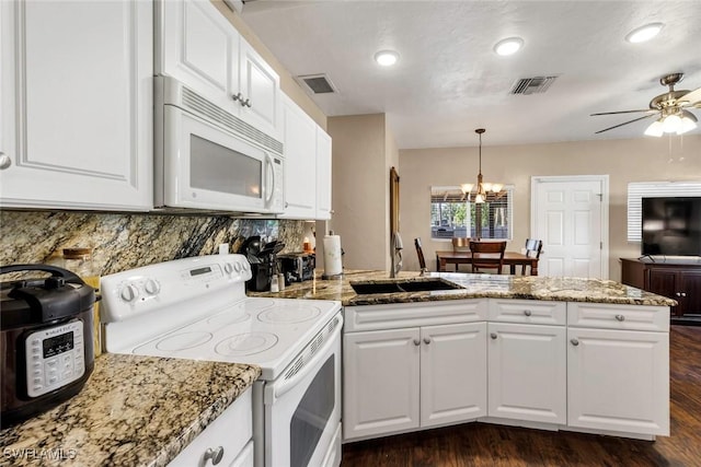 kitchen featuring dark hardwood / wood-style floors, decorative light fixtures, sink, white cabinets, and white appliances