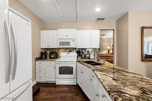 kitchen with white cabinetry, sink, decorative backsplash, dark stone counters, and white appliances