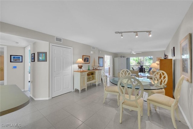 tiled dining space featuring ceiling fan and rail lighting