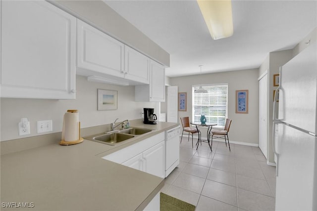 kitchen featuring light tile patterned flooring, pendant lighting, sink, white cabinets, and white appliances