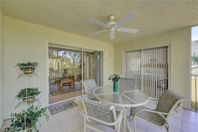 sunroom featuring ceiling fan