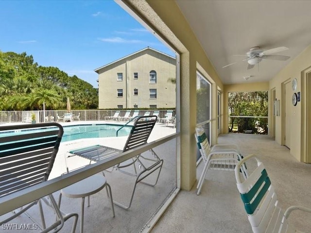 balcony with a patio and ceiling fan