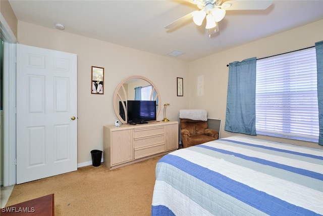 bedroom with light carpet and ceiling fan