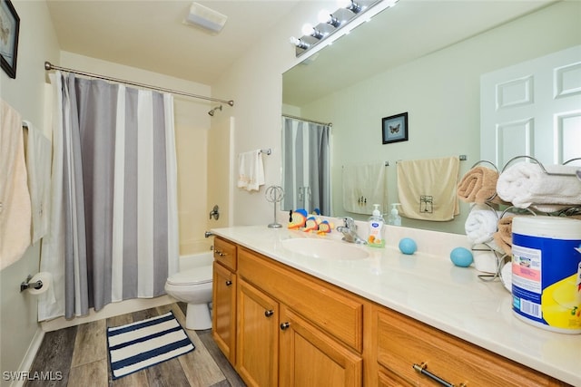 full bathroom with vanity, hardwood / wood-style floors, shower / bath combo, and toilet