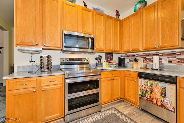 kitchen with appliances with stainless steel finishes and light wood-type flooring