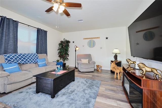 living room featuring hardwood / wood-style flooring and ceiling fan