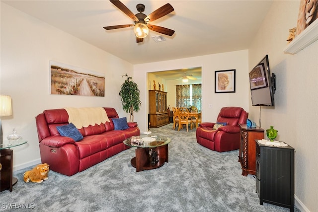 carpeted living room with ceiling fan