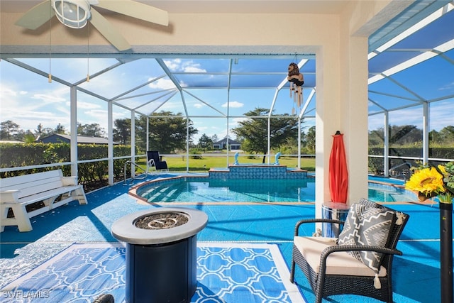 view of swimming pool with a patio, a lanai, and an outdoor fire pit